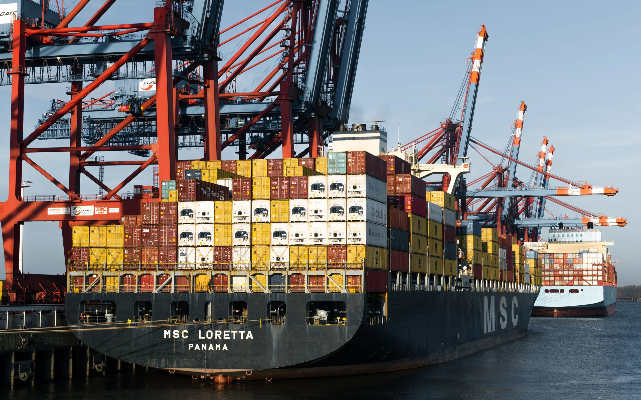 Container ships and cranes at the port of Hamburg. Illustrative logistics photograph.